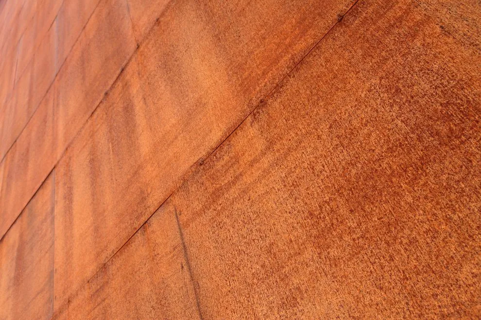 Close-up of the rust-brown weathered surface of COR-TEN steel