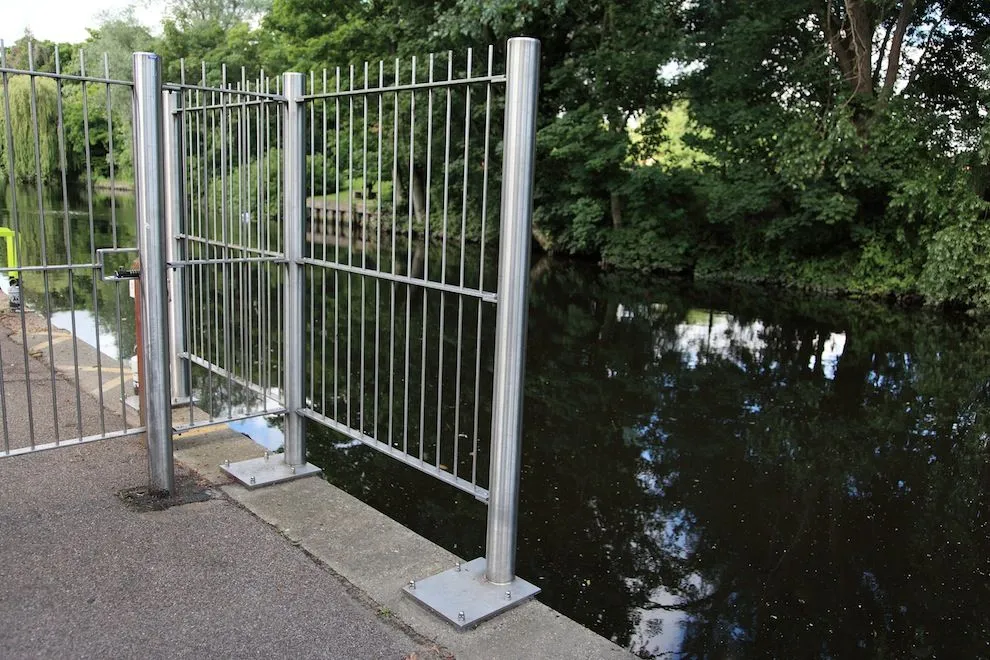 Stainless steel riverside railings and gate along the water's edge in Norwich
