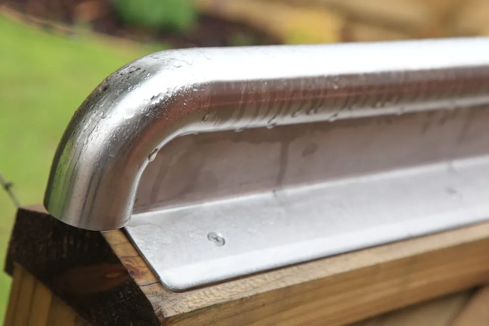 End of a stainless steel capping rail on a timber edge