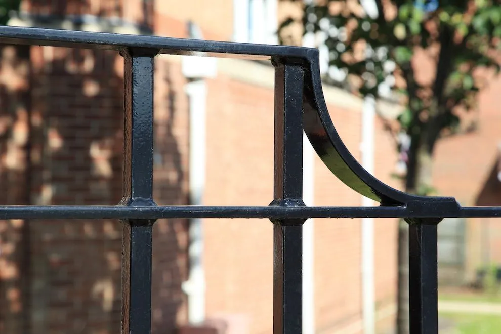 Detail of black steel railings with a curved top bracket