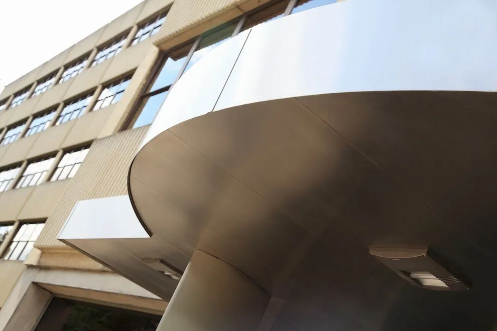 Underside of the curved stainless steel canopy with recessed lights