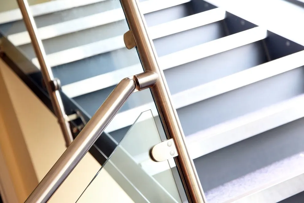 Stainless steel handrail and glass balustrade on an internal staircase