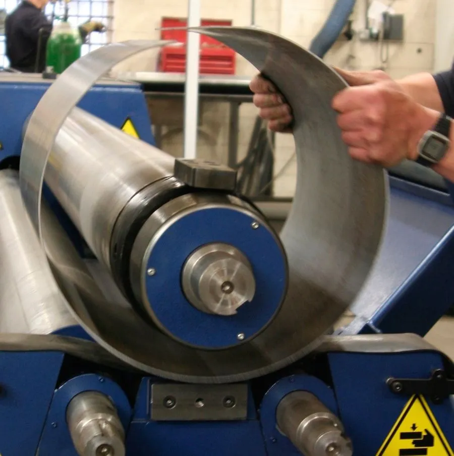 Sheet steel being rolled into a cylinder on a plate-rolling machine
