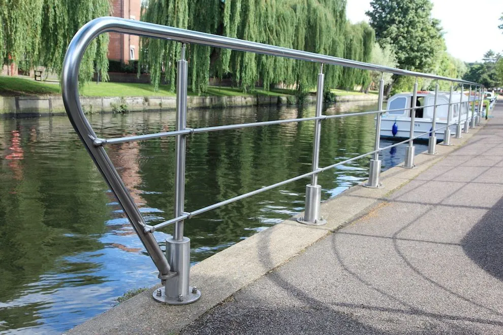 Stainless steel railings along a riverside walkway