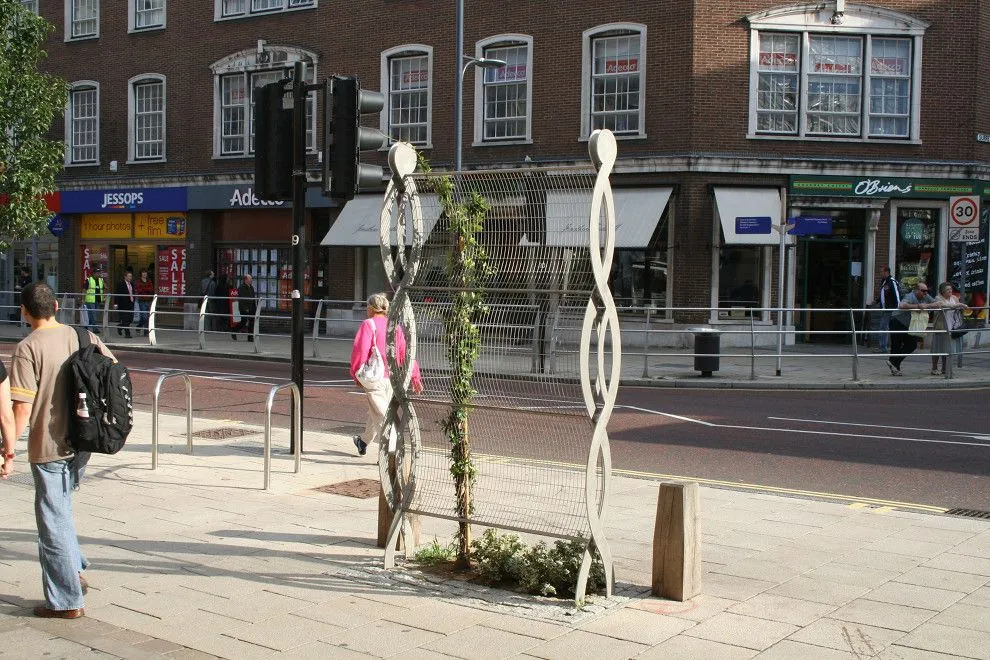Twisted steel climbing-plant supports on the pavement of St Stephens Street, Norwich