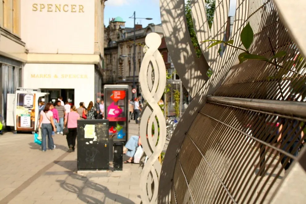 Twisted steel plant support and curved steel screen on St Stephens Street