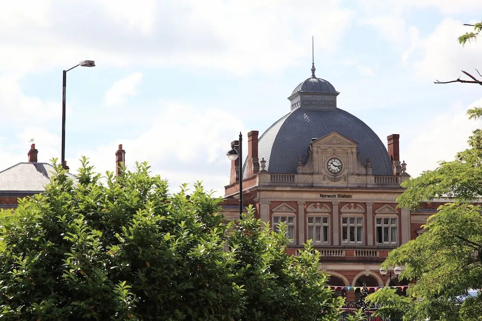 Norwich railway station's domed roof above the trees